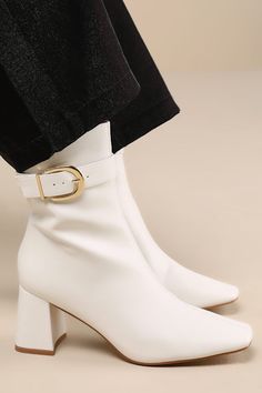 Strut into the changing season with chic confidence in the Lulus Joplynn Bone Buckle Ankle Boots! Smooth faux leather shapes these stylish lil' boots with a squared, pointed-toe upper and seaming at the center that rises to an ankle-high shaft. An adjustable, gold buckle strap accents the outstep, while an 8"" zipper at the instep makes for easier on-and-off. Sturdy block heel completes the look! 2. 75" wrapped block heel. Cushioned insole. Rubber sole has nonskid markings. Man made materials. I Ankle High Heel Boots, Double Nostril, Ivory Shoes, Casual Formal Dresses, Buckle Ankle Boots, Lulu Fashion, Comfortable Boots, Shoes Boots Ankle, Boots Ankle