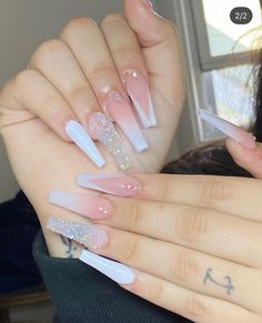 the woman is holding up her nails with white and pink designs on it's fingers