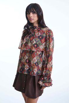 Add a touch of vintage charm to your wardrobe with this original printed blouse from James Lakeland. Crafted from sheer chiffon with gold threading, it features a 70’s inspired print. The long sleeves end in ruched, two-tiered ruffle cuffs, while a flowy panel graces the bust and back. The elegant ruffle collar fastens at the back with a single button, making it a standout piece for any occasion.     Made in Italy 100% Polyester Machine Wash at 30°C, Do not bleach, Permanent Press, Iron at Low Temperature, Dry Clean any solvent except trichloroethylene, Do Not Tumble Dry. Button Making, September Birthstone Jewelry, Shirt Blouses Women's, Gifts For New Mums, Zodiac Jewelry, Sheer Chiffon, Pearl Jewellery Earrings, Ruffle Collar, Jewelry Ring Box