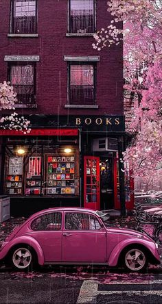 a pink car parked in front of a book store