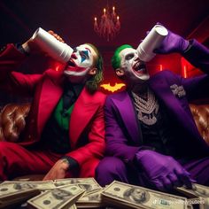 two men dressed as jokers sitting on a couch with stacks of money in front of them