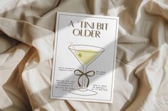 a book with an image of a martini glass on it's cover and the title, a tin bit older