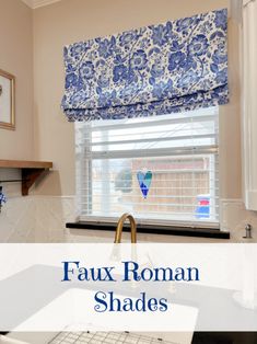 the roman shades in this kitchen are blue and white