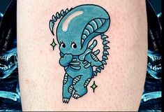 a blue dragon tattoo on the right thigh with stars around it and an arrow in the middle