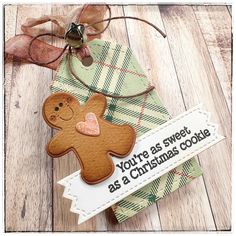 a christmas card with a gingerbread cookie on it and a tag that says, you're as sweet as a christmas cookie