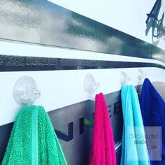 three towels hanging on the wall next to each other in front of a towel rack