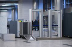 an airport lobby with metal turns and doors