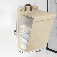 an open canvas storage bag next to a door with clothes in it and measurements for the size