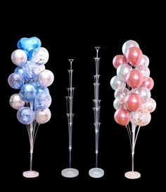 three tall clear vases with balloons in them