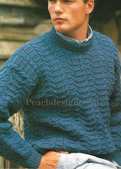 a young man in a blue sweater is sitting on a wooden bench with his hands on his hips