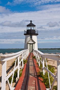 a light house sitting on top of a wooden bridge