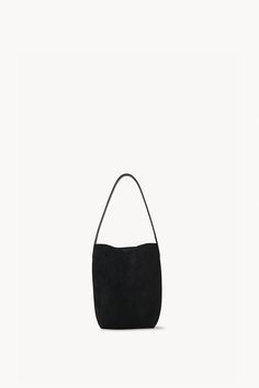 Classic tote bag in soft suede with interior tie closure and flat handle. Chic Suede Bag For On-the-go, Everyday Suede Bucket Bag With Soft Leather, Luxury Everyday Suede Bucket Bag, Luxury Suede Bucket Bag For Everyday, Double Handle Suede Bucket Bag With Soft Leather, Chic Suede Bucket Bag For Everyday, Suede Bucket Bag With Soft Leather, Soft Suede Bucket Bag For Daily Use, Suede Tote Shoulder Bag With Handle Drop