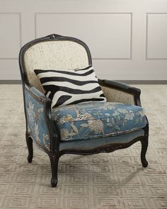 a zebra print chair sitting on top of a rug next to a white wall and door