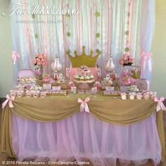 a table with pink and gold desserts, cupcakes and cakes on it