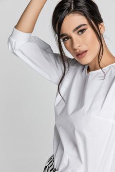 White top with ¾ length raglan bishop sleeves. Round neckline which fastens in the back with a button. Darts at the bust. Straight silhouette. Our model is 176cm and is wearing size 36/S. Measurements for size 36/S (in cm): Shoulder -46, Chest-51, Waist-51, Bottom-51, Sleeve length -45, Body length-58. Accessories are not included. 92% cotton-8% elastan Gentle machine wash. Turn garment inside out. Cold water. Mild detergent. Iron on reverse side. Do not tumble dry. Do not bleach. White Top Women, Busy Lifestyle, Professional Women, Fashion Jewellery, Independent Designers Fashion, Badger, White Top, White Tops, Fashion Collection