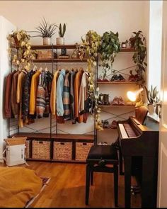 a room filled with lots of clothes hanging on shelves next to a piano and potted plants