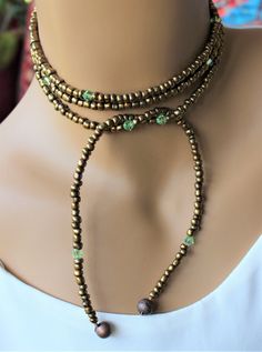 This beautiful lariat is comprised of bronze seed beads with peridot glass accents. Handmade Lariat Festival Necklace, Festival Handmade Lariat Choker, Handmade Lariat Choker For Festival, Handmade Festival Lariat Necklace, Unique Lariat Jewelry For Festivals, Unique Lariat Necklaces For Festival, Bohemian Lariat Choker As Gift, Unique Lariat Necklace For Festivals, Adjustable Beaded Lariat Necklace For Festivals