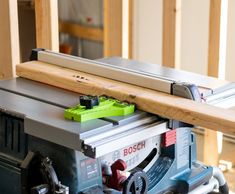 a table saw sits on top of a piece of wood