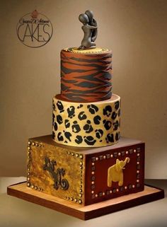 a three tiered cake with animal print on it