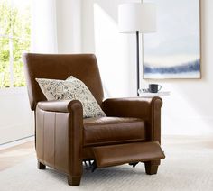 a brown chair sitting on top of a white rug