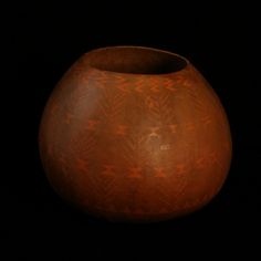 a brown vase sitting on top of a black table