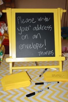 a yellow baby shower sign sitting on top of a table