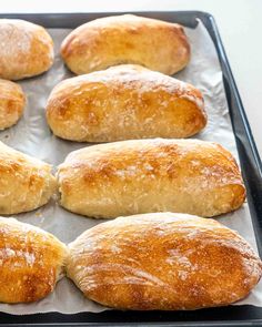 several loaves of bread sitting on top of a baking sheet in an oven pan