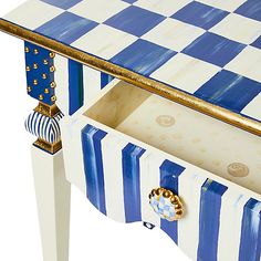 a blue and white checkered table with gold accents