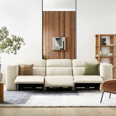 a living room filled with furniture and a large mirror