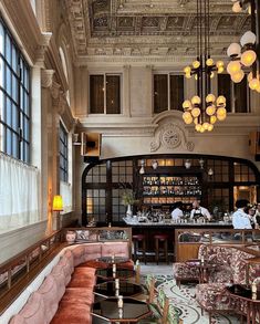 an ornately decorated restaurant with chandeliers hanging from the ceiling