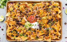 an overhead view of nachos in a baking dish