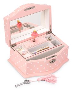 a pink jewelry box with white polka dots