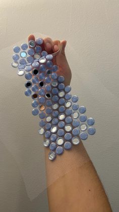 a person's arm is covered with blue and white circles, which are arranged in the shape of bubbles