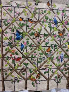 a quilt with birds and flowers on it