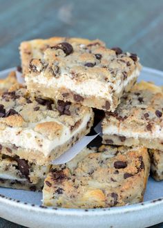 chocolate chip cookie bars stacked on top of each other in a white plate with paper