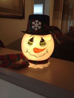 a light up snowman sitting on top of a counter