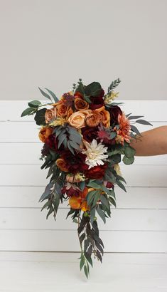 a bridal bouquet with orange and red flowers