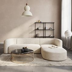 a living room with a large white couch and coffee table in the middle of it