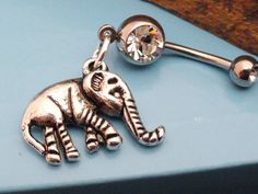 an elephant belly ring is shown on top of a blue surface with a rock in the background