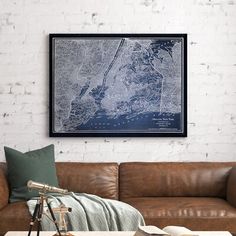 a living room with a couch, coffee table and large map on the wall