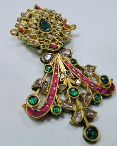 A beautiful rare find antique turban pin from the house of Maharaja of Rajasthan, encrusted with old mine cut Diamonds, Rubies, Emeralds set in 20 carats solid Gold and back adorned with multicolor enamel exquisite work, Detailed Kundan Meen work an Original classic collectors piece which could be easily adopted into two individual pendants or Brooch and a pendant. a very versatile piece in good condition. Size of piece-9.5/5.5 cm, total weight-45.6 grams(1.60 ounces). Material-solid 20 carat go Traditional Ceremonial Brooch Jewelry, Traditional Brooch With Intricate Design As Gift, Traditional Brooches With Intricate Design As Gift, Traditional Brooches With Intricate Design For Gifts, Traditional Pendant Brooches As Gifts, Mughal Jewelry, Royal Diamond, Silver Bead Bracelet, Ruby Emerald