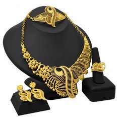 Indulge in luxury with this exquisite Dubai Gold Necklace Set, perfect for wedding parties. With its opulent design and superior craftsmanship, this set features a necklace, bracelet, earrings, and ring. Make a lasting impression and elevate your style with this luxurious jewelry set." Formal Plated Alloy Jewelry, Formal Gold Alloy Jewelry, Gold Plated Fine Jewelry Sets For Wedding, Fine Gold Plated Jewelry Sets For Wedding, Fine Jewelry Gold-plated Wedding Jewelry Sets, Yellow Gold Plated Jewelry For Wedding, Gold Fine Jewelry For Wedding, Elegant Gold Alloy Bridal Necklace, Gold Alloy Jewelry With Elegant Design