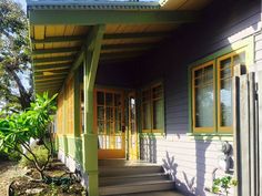 the front porch of a house with steps leading up to it's door and windows