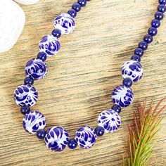 Working with hand-formed and painted ceramic beads from Puebla artisan Monica Vazquez creates this beautiful pendant necklace. The ceramic beads alternate with lapis lazuli beads and additional lapis beads make up the rest of the necklace. The necklace features a sterling silver spring ring clasp.