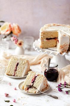 two slices of cake on plates with flowers in the background and one slice is missing