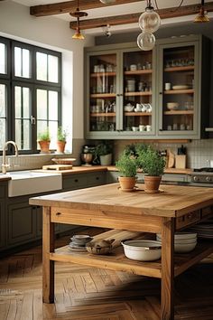 a wooden table sitting in the middle of a kitchen