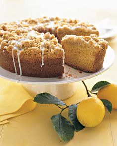 a cake on a plate with lemons next to it