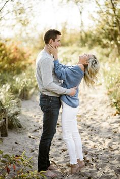 a man and woman embracing each other on the beach