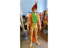 a man dressed in an orange and green costume