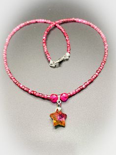 This is a gorgeous Pink Glass Handmade Necklace with Pink Crystal Glass Star Pendant approximately 16 inches.  It is approx 16 inches in length and finished with a silver colour spring ring clasp. The body of this necklace features gorgeous dark pink triangle silver colour lined seed beads and is set with a stunning crystal star centrepiece which is in orange and pink colourway and offset with bright pink faceted glass beads. I also have gorgeous matching earrings which can be viewed in my shop. To view more JulieDeeleyJewellery items from my shop please click link below : http://www.etsy.com/shop/JulieDeeleyJewellery JULIE DEELEY JEWELLERY SOCIAL MEDIA LINKS Follow me on Facebook: www.facebook.com/juliedeeleyjewellery Follow me on Twitter: twitter.com/julie_deeley Follow me on Pinterest: Star Centerpieces, Pink Triangle, Glass Stars, Crystal Stars, Silver Colour, Faceted Glass, Pink Glass, Handmade Necklace, Star Pendant